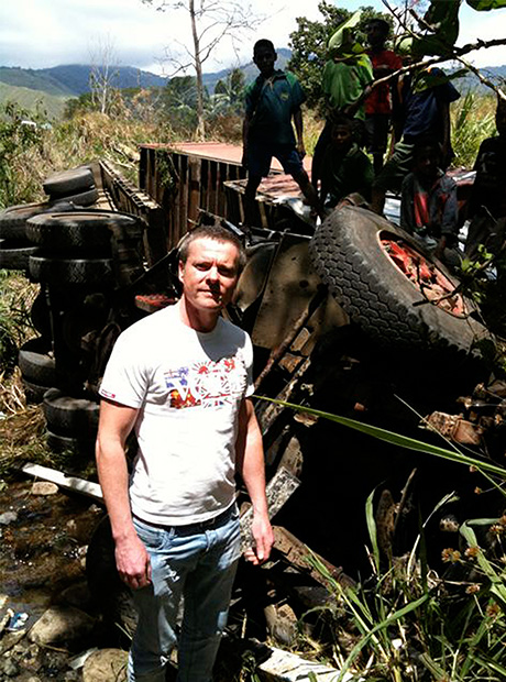 UMM PNG MD Glen Scott stands alongside a roadside accident.