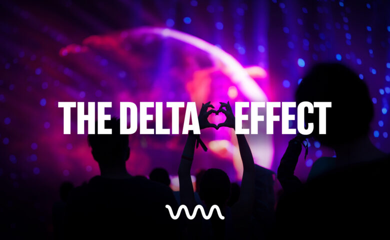 Silhouetted concert crowd forming a heart with their hands against a purple-pink stage, with bold white text 'THE DELTA EFFECT' overlaying the image.