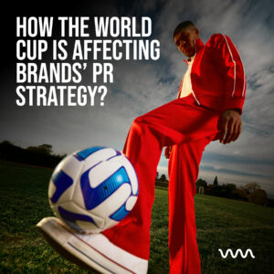 Hero image of a soccer player in a red tracksuit kicking a ball on a field, with bold white article title about how the World Cup affects brands' PR strategy.